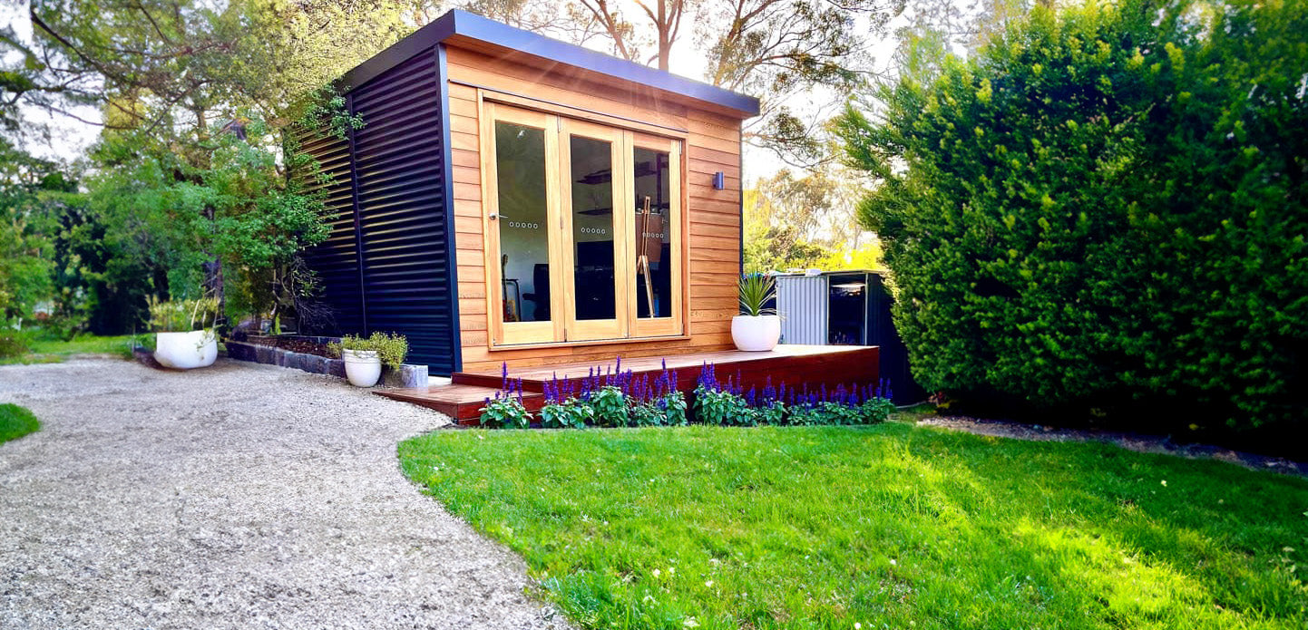 Hideout Plus Studio by Designer Hideaways — modern backyard retreat with Colorbond cladding and wide glass doors for natural light and connection to the outdoors.